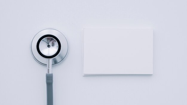 Stethoscope and business card in foreground