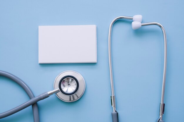 Stethoscope and business card with blue background