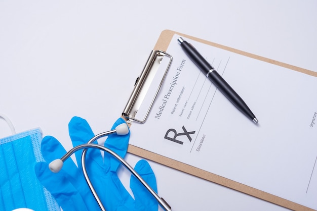 Stethoscope in doctors desk, medical concept. corona virus covid-19. stethoscope, eyeglasses and face mask on white desk. Protection against virus, coronavirus, flu, colds, diseases. flat lay top view