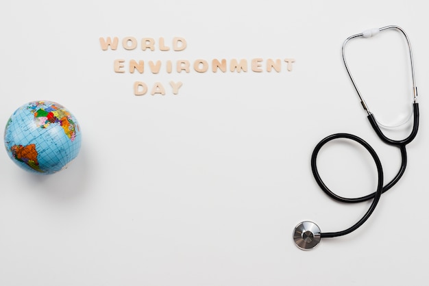 Stethoscope and globe with Word environment day text