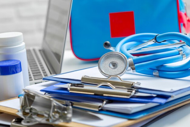 Stethoscope lying on medical form on clipboard .