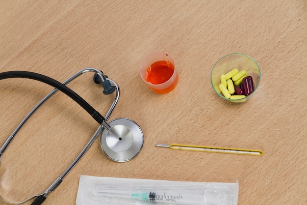 Stethoscope and pills in glass