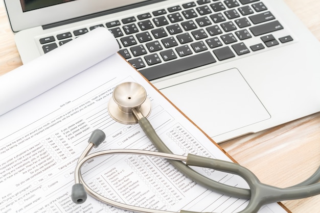 Stethoscope and prescription on laptop