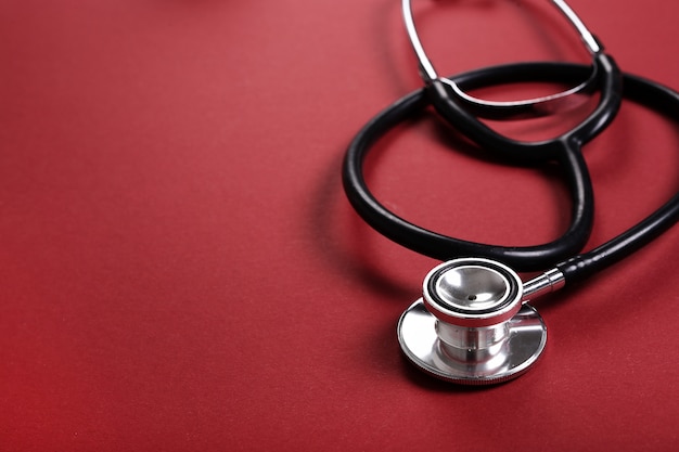 Stethoscope on red surface