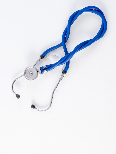 Stethoscope on a white desk, top view