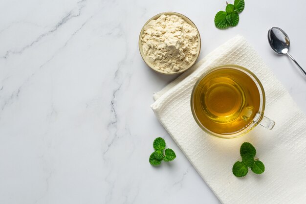 Stevia tea in a glass cup on the table