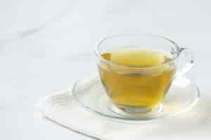 Free photo stevia tea in a glass cup on the table