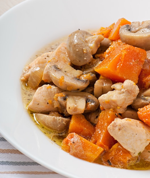 Stew chicken with vegetables and mushrooms in a cream sauce