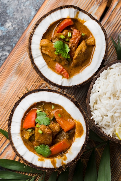 Free photo stew and rice in coconut plates top view