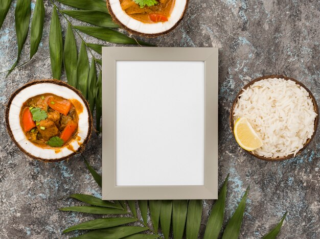 Stew and rice in coconut plates with empty frame