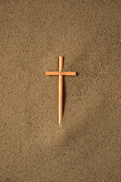 Stick cross on the sand