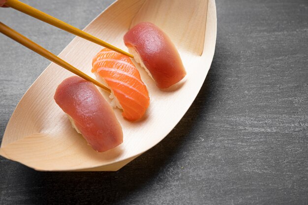 Sticks holding raw fish with rice