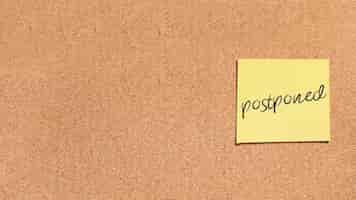 Free photo sticky note with postponed message