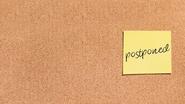 Sticky note with postponed message