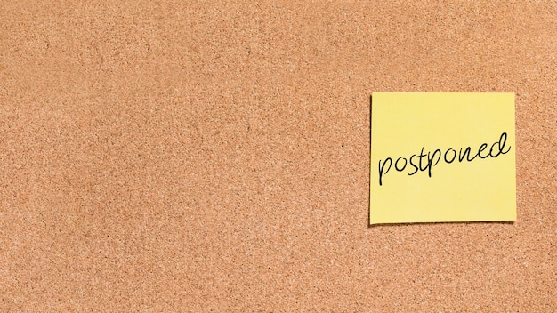 Sticky note with postponed message