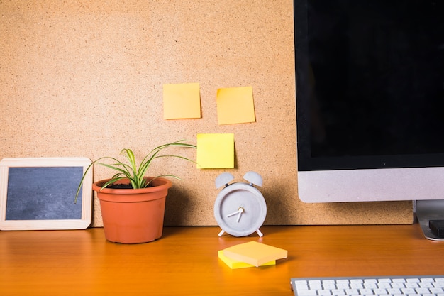 Sticky notes and table decorations near monitor