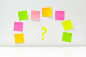 Sticky notes with question marks over white