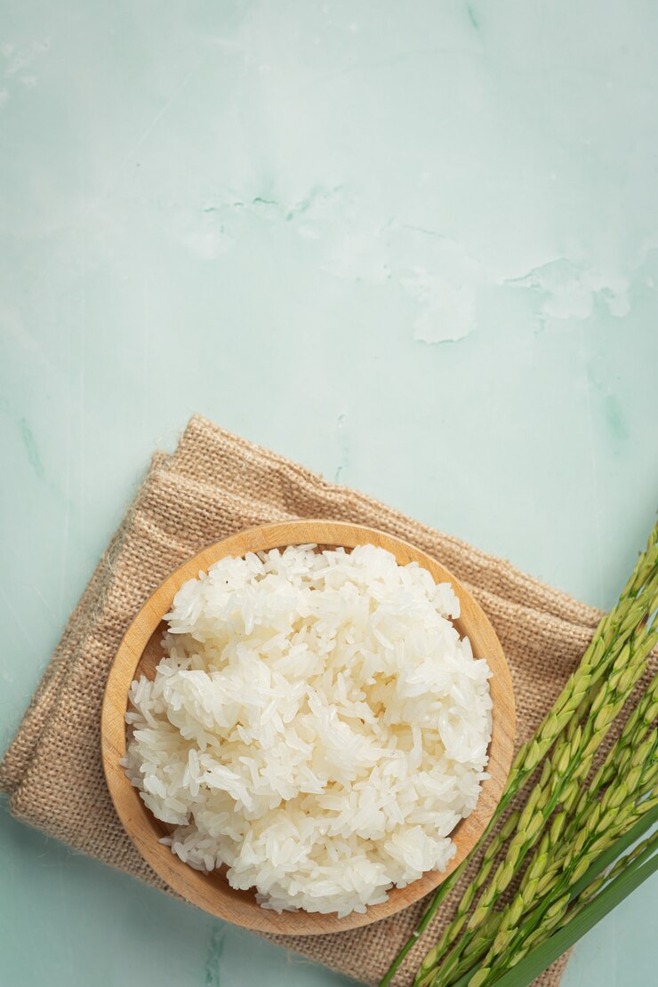 Free Photo sticky rice with rice plant place on brown fabric