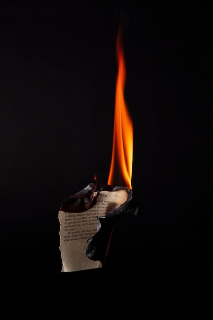 Free photo still life of burnt paper with flames