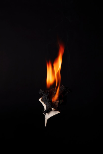 Free photo still life of burnt paper with flames