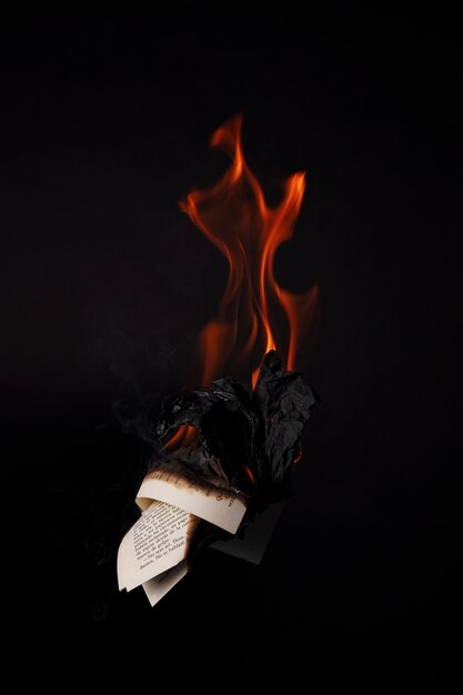 Still life of burnt paper with flames