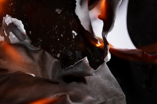 Free photo still life of burnt paper with flames