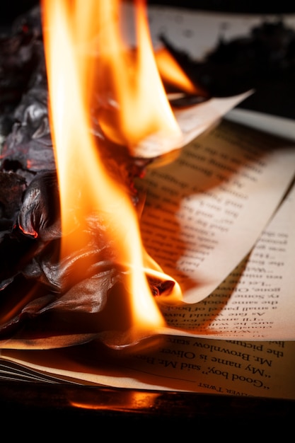 Free photo still life of burnt paper with flames