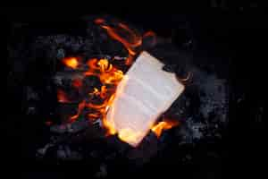 Free photo still life of burnt paper with flames