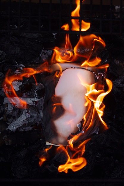 Still life of burnt paper with flames