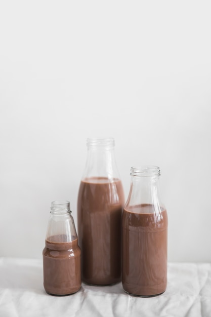 Still life of chocolate milkshake bottle against white background