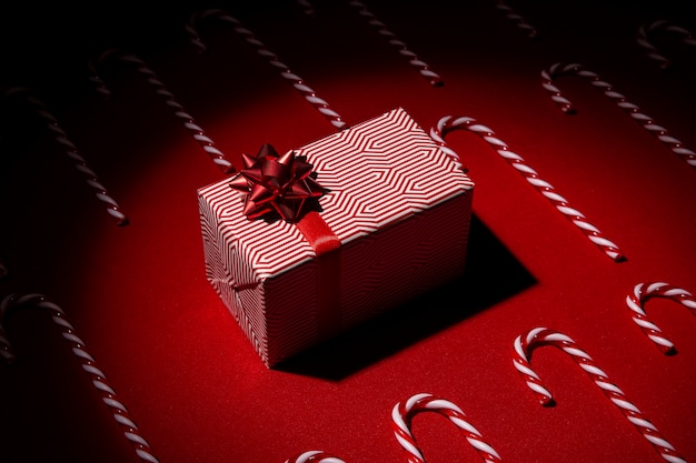 Free photo still life of christmas gift box with candy cane