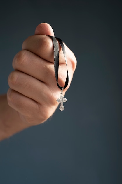 Free photo still life of crucifix held in hand