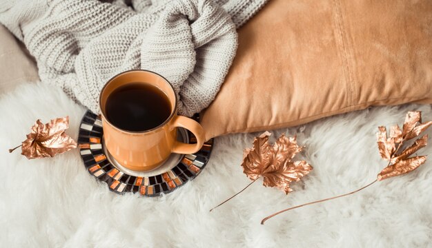 Still life Cup of tea with autumn leaves and sweater.