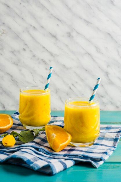 Free photo still life of delicious orange smoothie