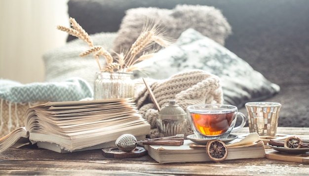 Still life details of home interior on a wooden table with a Cup of tea