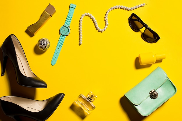 Still life of fashion woman, objects on yellow