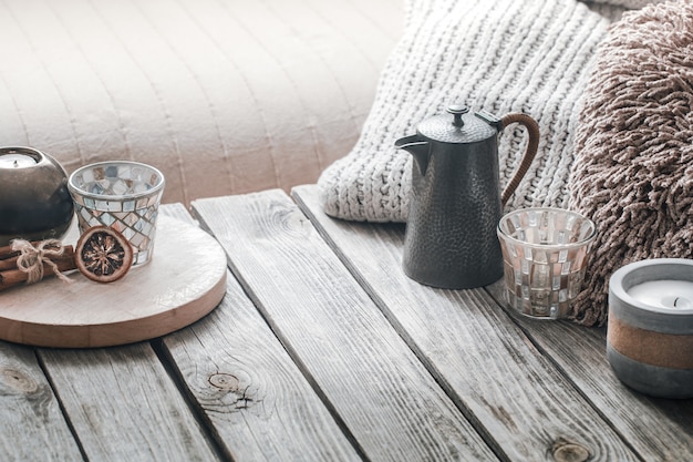 Free photo still life from home interior on a wooden background with a candle