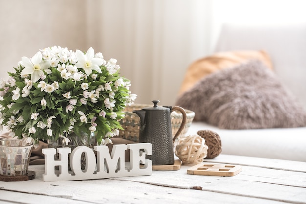 Free photo still life in the living room with wooden inscription home