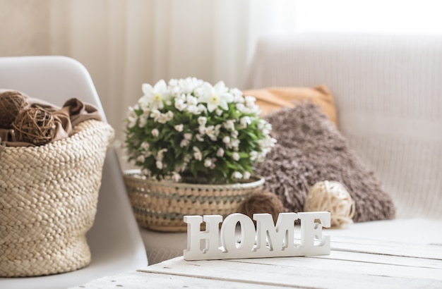 Free photo still life in the living room with wooden inscription home