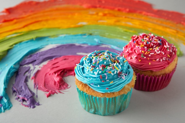 Free photo still life of rainbow cupcakes