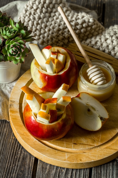 Still life with apples on wood. Apples cut into strips.