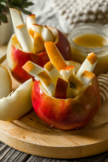 Still life with apples on wood. Apples cut into strips.