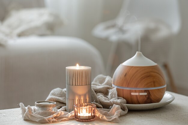 Still life with an aroma diffuser for moisturizing the air and burning candles.