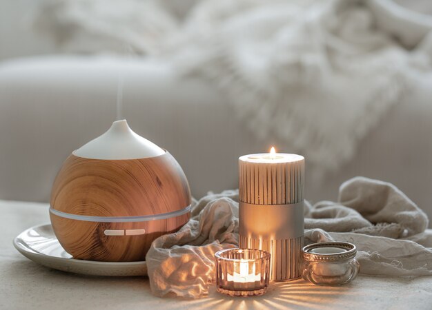 Still life with an aroma diffuser for moisturizing the air and burning candles.