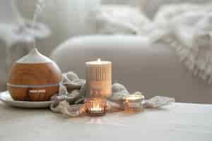 Free photo still life with an aroma diffuser for moisturizing the air and burning candles.