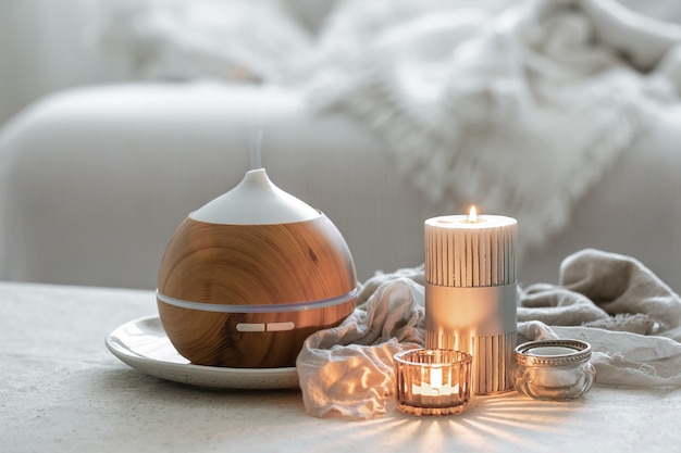 Still life with an aroma diffuser for moisturizing the air and burning candles.