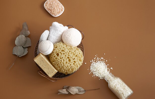 Still life with a bath sponge, bath bombs, soap and sea salt.