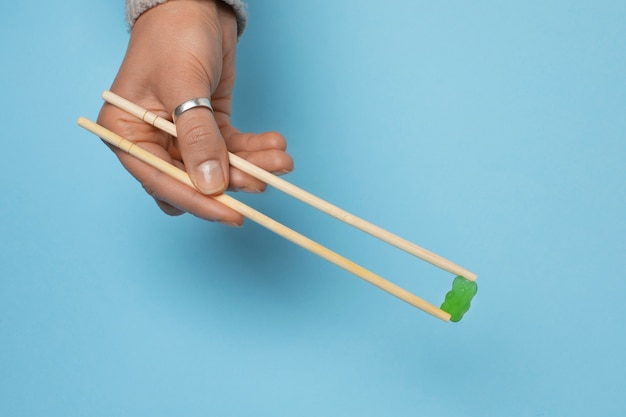 Still life with colorful gummy in chopsticks