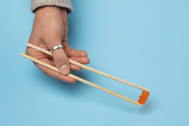 Still life with colorful gummy in chopsticks