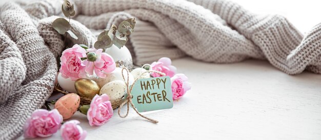 Still life with details of the festive Easter decor and the inscription Happy Easter on the postcard.